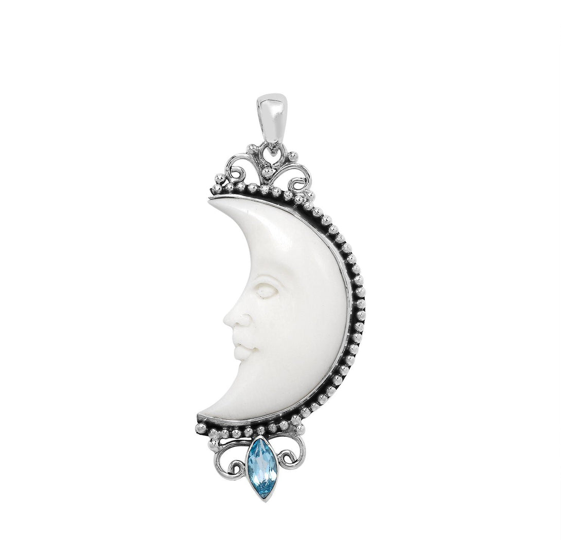 Sterling silver crescent moon pendant with carved bone face and marquise blue topaz gemstone, Balinese artisan jewelry.