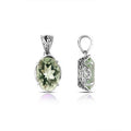 Sterling silver pendant with oval-cut green amethyst quartz, handcrafted in Bali with scroll detailing and oxidized finish.
