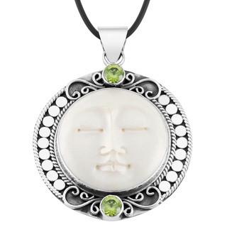Wholesale Peridot Quartz and carved bone face sterling silver pendant handcrafted in Bali with Balinese artistry.