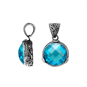 A beautifully crafted 925 sterling silver pendant featuring a faceted round Blue Topaz Quartz stone set in a traditional Balinese design with ornate detailing on the sides.