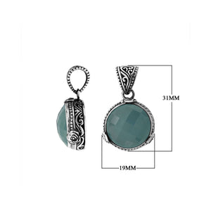 A beautifully handcrafted 925 sterling silver pendant showcasing a round faceted Blue Chalcedony Quartz stone surrounded by traditional Balinese patterns and ornate engraved details on the frame.