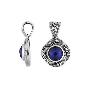 A handcrafted sterling silver pendant featuring a rich Sapphire Quartz surrounded by intricate swirl filigree detailing, reflecting the refined artistry of traditional Balinese jewelry design.