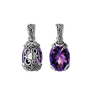 A handcrafted sterling silver pendant featuring a vibrant Amethyst Quartz set in an oval filigree frame, reflecting the intricate charm of Balinese artistry.