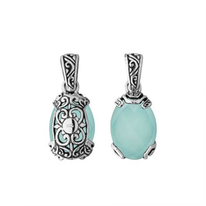 A handcrafted sterling silver pendant featuring a serene Green Chalcedony Quartz set in an ornate Balinese filigree frame with detailed silver artistry.