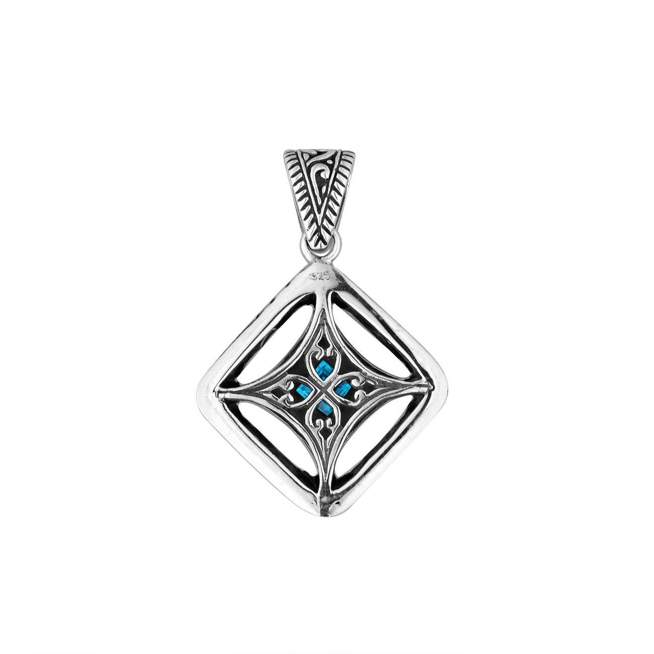 A handcrafted sterling silver pendant featuring a radiant Blue Topaz Quartz in a detailed Balinese filigree square frame with artistic silverwork.