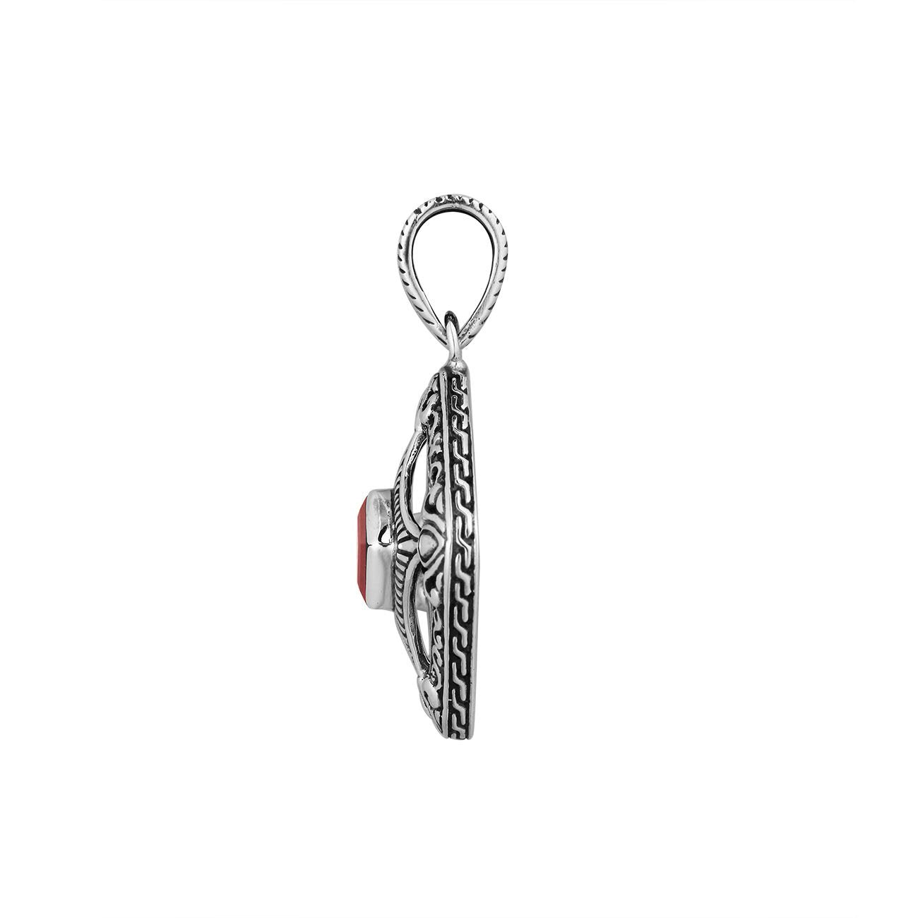 A handcrafted sterling silver pendant featuring a radiant Red Garnet Quartz in a Balinese filigree square frame with detailed silverwork.
