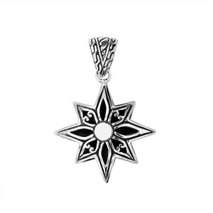 A handcrafted sterling silver compass star pendant featuring detailed Balinese tribal engraving and polished silver craftsmanship.