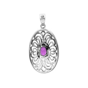 A handcrafted sterling silver pendant featuring a radiant Amethyst Quartz centered in a detailed Balinese filigree oval frame.