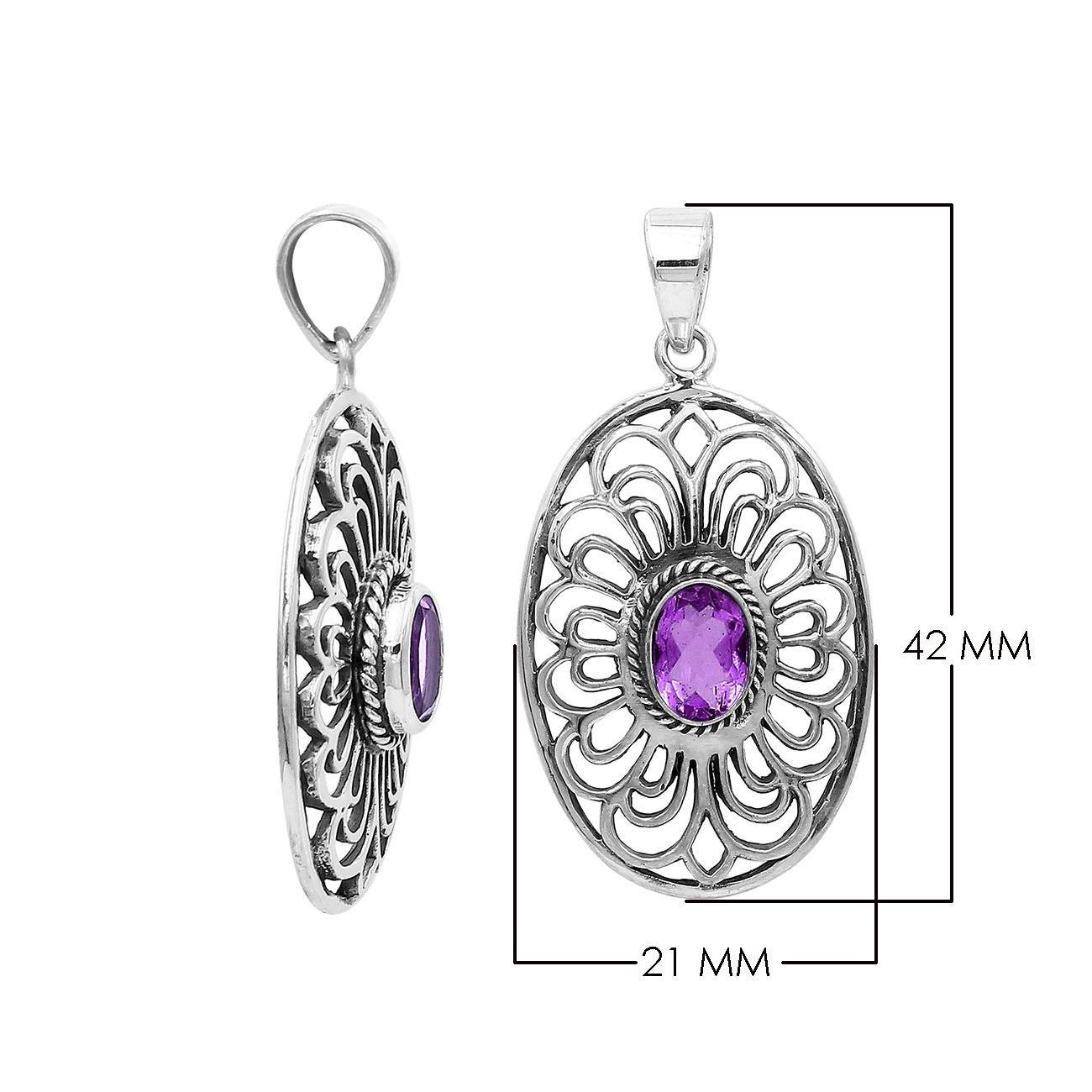 A handcrafted sterling silver pendant featuring a radiant Amethyst Quartz centered in a detailed Balinese filigree oval frame.