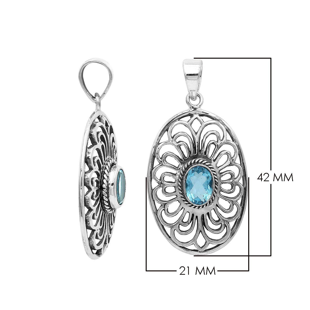 A handcrafted sterling silver pendant featuring a radiant Blue Topaz Quartz gemstone centered in an elegant Balinese filigree oval frame.