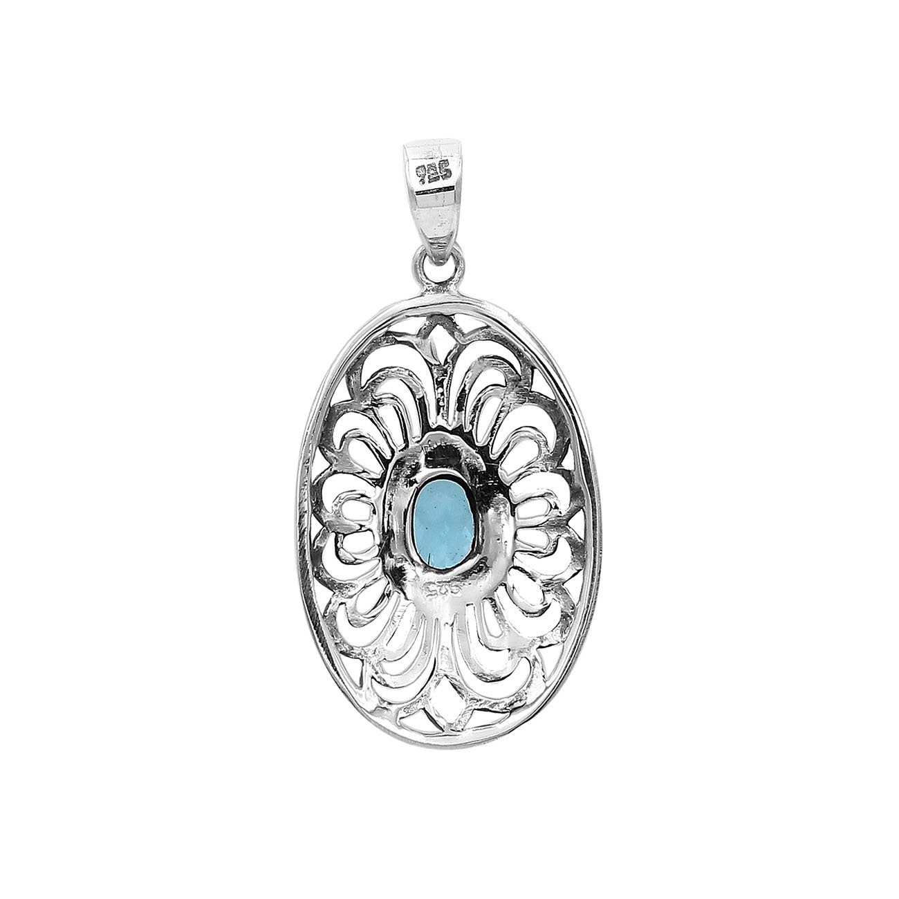 A handcrafted sterling silver pendant featuring a radiant Blue Topaz Quartz gemstone centered in an elegant Balinese filigree oval frame.