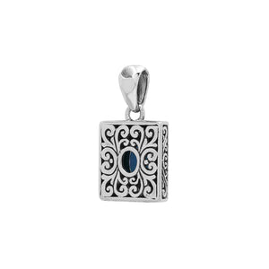Rectangular sterling silver pendant featuring oval blue topaz quartz, swirl engravings, and smooth mirror-polished finish with detailed Balinese craftsmanship.