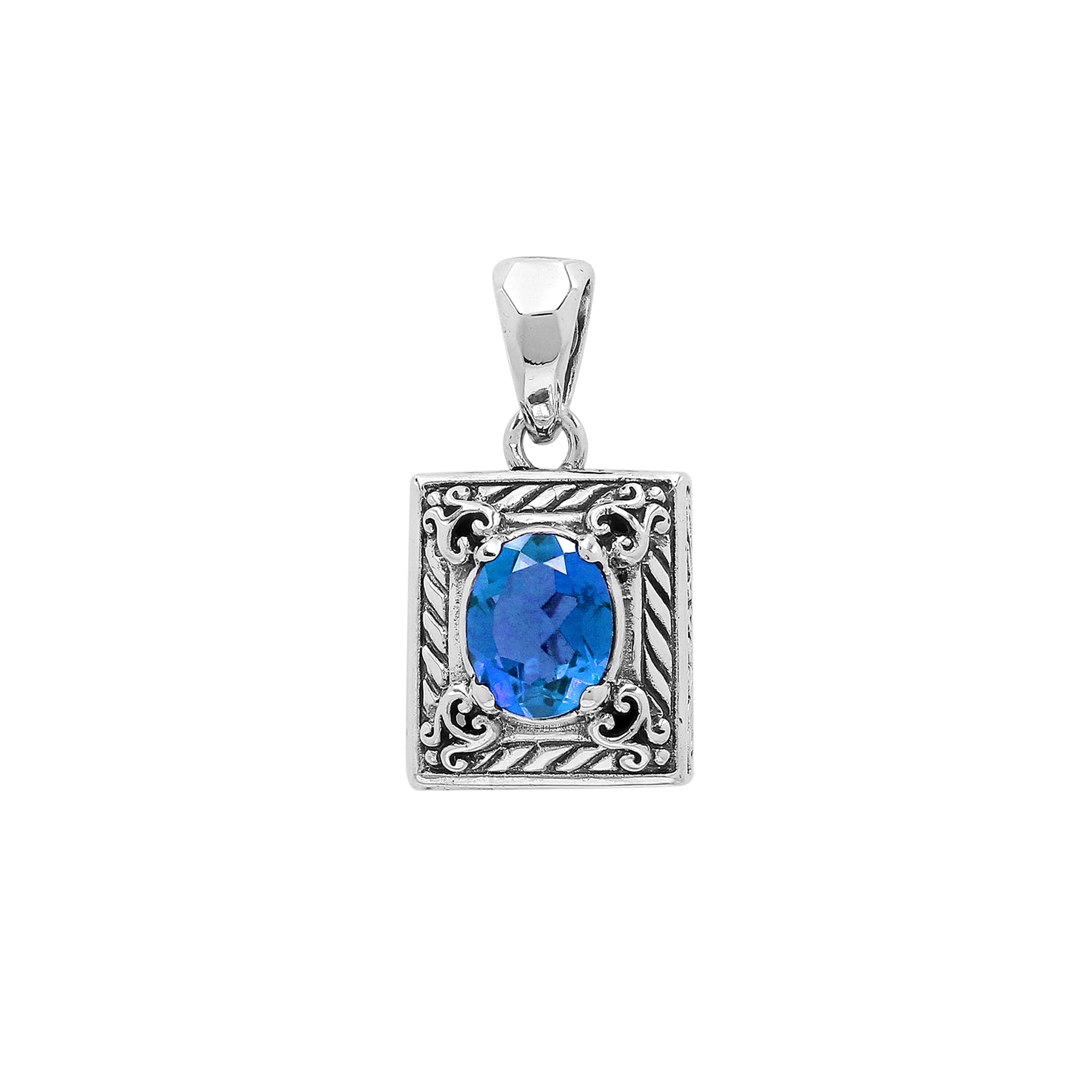 Rectangular sterling silver pendant featuring oval blue topaz quartz, swirl engravings, and smooth mirror-polished finish with detailed Balinese craftsmanship.