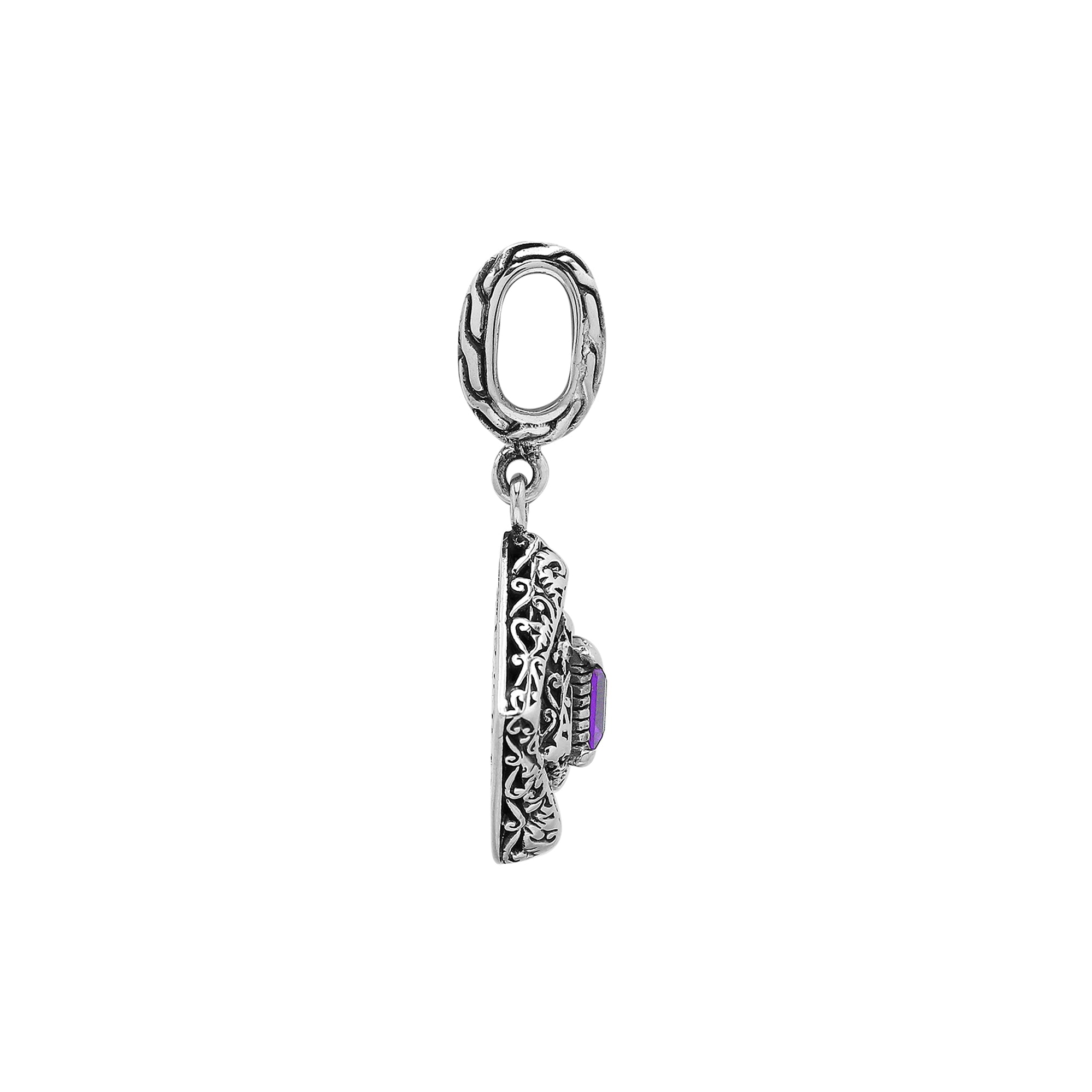Diamond-shaped sterling silver pendant featuring square amethyst quartz centerpiece, filigree engraving, and smooth polished finish in classic Balinese design.