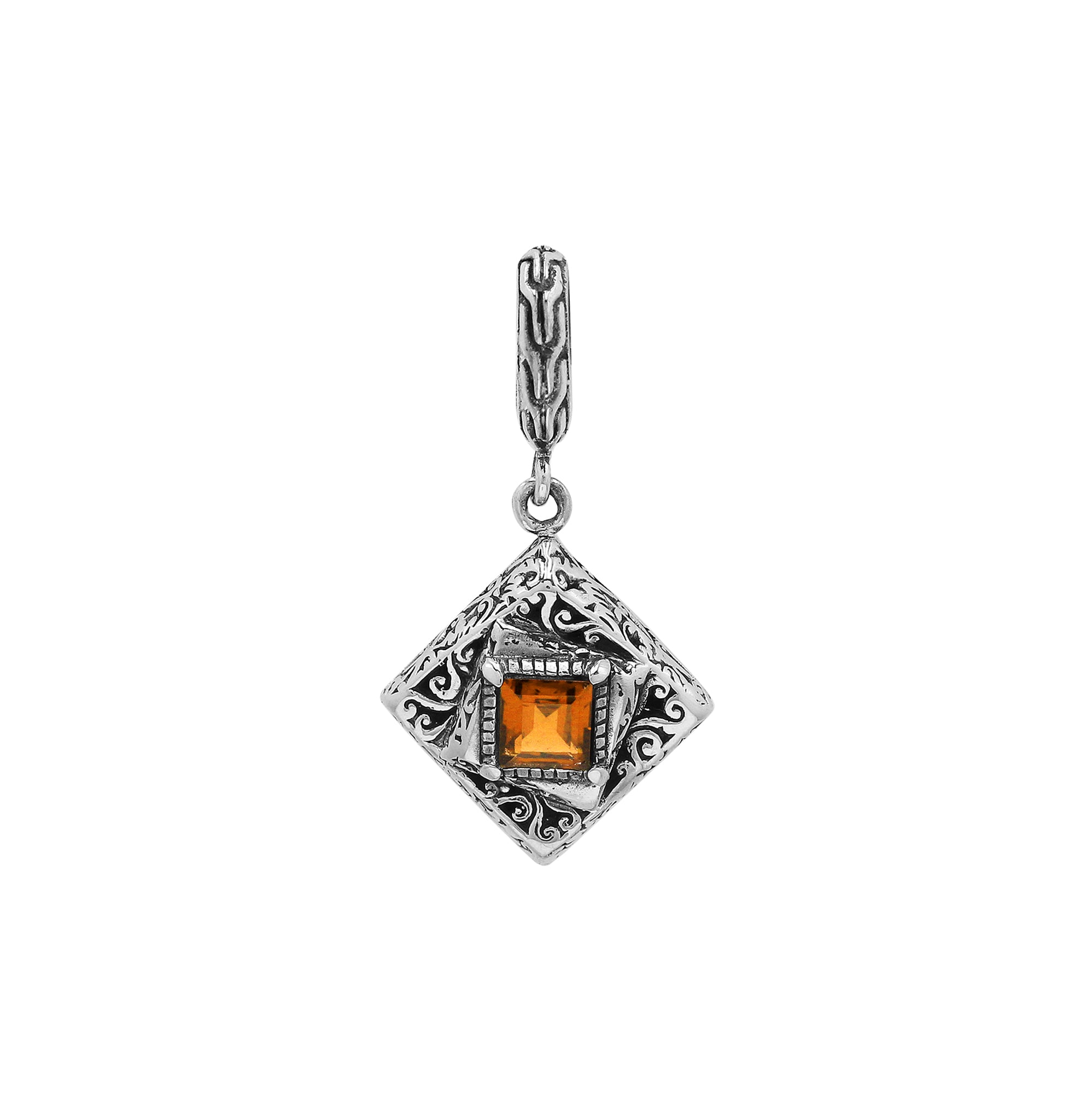 Diamond-shaped sterling silver pendant featuring citrine quartz square center with filigree engravings and polished finish in traditional Balinese design.