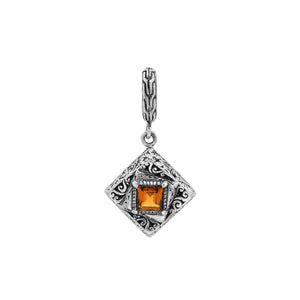 Diamond-shaped sterling silver pendant featuring citrine quartz square center with filigree engravings and polished finish in traditional Balinese design.