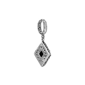 Diamond-shaped sterling silver pendant featuring citrine quartz square center with filigree engravings and polished finish in traditional Balinese design.