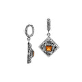 Diamond-shaped sterling silver pendant featuring citrine quartz square center with filigree engravings and polished finish in traditional Balinese design.