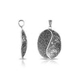 Sterling silver oval pendant featuring Yin-Yang filigree texture with oxidized handcrafted Balinese finish.