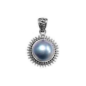 Sterling silver round pendant with gray Mabe Pearl and oxidized Balinese handcrafted beaded frame.