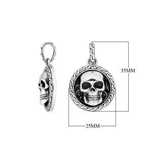 Sterling silver round skull pendant with carved texture and polished detailing.