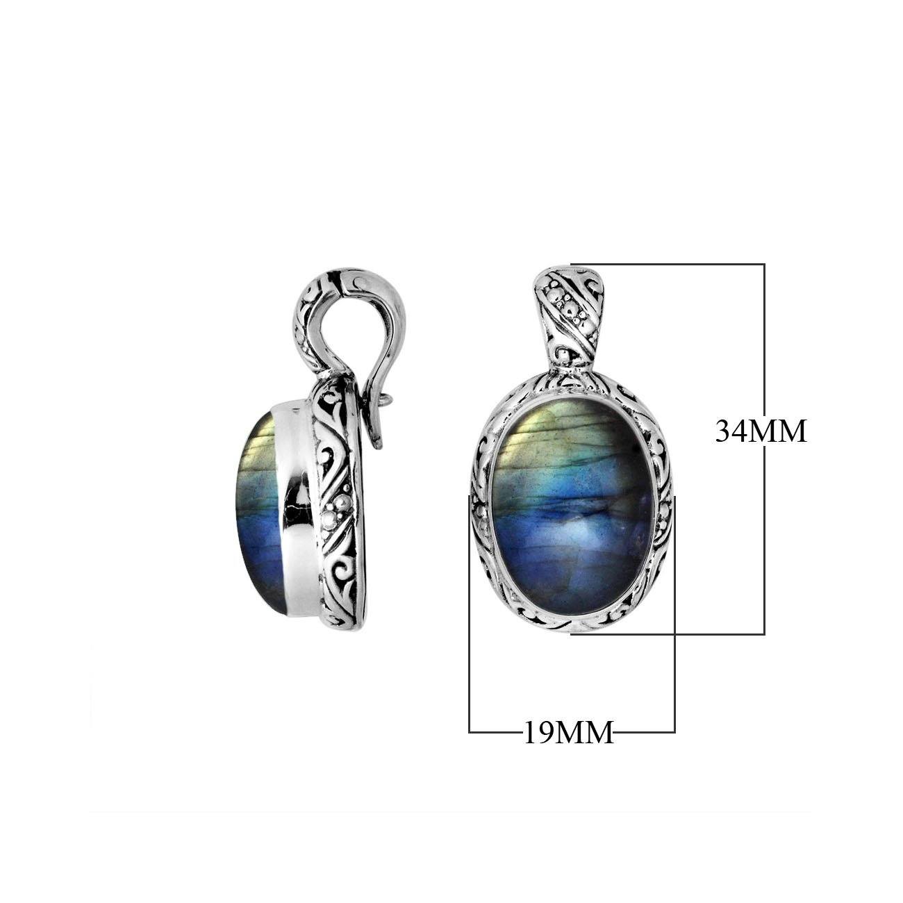 Sterling silver pendant featuring an oval Labradorite set in a carved traditional Balinese frame with polished shine.