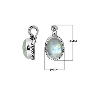 Sterling silver pendant featuring an oval Rainbow Moonstone set in a detailed Balinese carved frame with a polished glossy finish.
