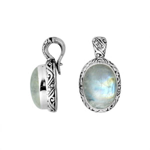 Sterling silver pendant featuring an oval Rainbow Moonstone set in a detailed Balinese carved frame with a polished glossy finish.