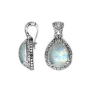 Sterling silver pendant featuring a teardrop Rainbow Moonstone set in a carved Balinese frame with a polished glossy finish.