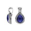 Sterling silver pendant featuring a faceted Sapphire Quartz teardrop set in a carved Balinese frame with a polished glossy finish.