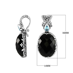 Sterling silver pendant featuring Black Onyx with Blue Topaz Quartz accent set in a carved Balinese frame and polished to a glossy shine.