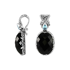Sterling silver pendant featuring Black Onyx with Blue Topaz Quartz accent set in a carved Balinese frame and polished to a glossy shine.