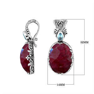 Sterling silver pendant featuring Ruby Quartz with Blue Topaz Quartz accent set in a carved Balinese frame with a polished glossy finish.