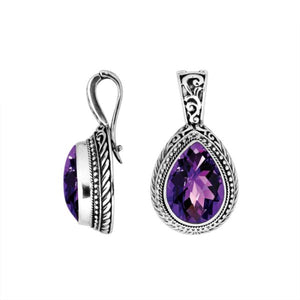 Sterling silver pendant featuring a faceted Amethyst Quartz teardrop set in a carved Balinese frame with a glossy polished finish.