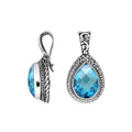 Sterling silver teardrop pendant featuring faceted Blue Topaz Quartz set in a carved Balinese frame with a polished glossy finish.