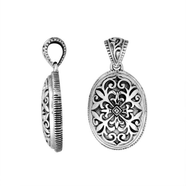 Wholesale sterling silver oval pendant with ornate floral carved design.