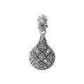 A wholesale sterling silver and 18K gold drop-shaped pendant featuring diamond accents, geometric Balinese engravings, oxidized textures, and detailed two-tone craftsmanship ideal for bulk jewelry buyers.