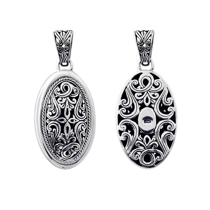 A wholesale Silver Overlay Over Copper oval pendant featuring intricate Balinese filigree detailing, oxidized depth, ornate scrollwork, and polished silver highlights ideal for bulk jewelry buyers.