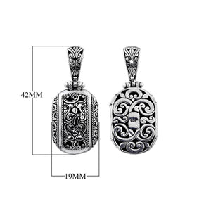 A wholesale Silver Overlay Over Copper oval pendant featuring ornate Balinese scrollwork, oxidized detailing, polished highlights, and a refined silver overlay design ideal for bulk jewelry buyers.