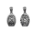 A wholesale Silver Overlay Over Copper oval pendant featuring detailed Balinese scrollwork, oxidized antique textures, polished overlay accents, and traditional filigree artistry ideal for bulk jewelry buyers.