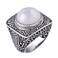 Wholesale sterling silver ring with bold square shank, featuring a large round white Mabe Pearl cabochon, accented with intricate oxidized Bali-style carvings, handcrafted artisan men’s statement jewelry.