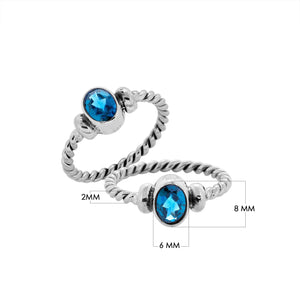 Bulk sterling silver twisted band rings with oval faceted Blue Topaz Quartz, handcrafted 925 silver wholesale jewelry supply.