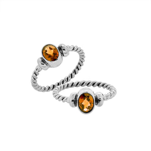 Bulk sterling silver twisted band rings with oval faceted Citrine Quartz, handcrafted 925 silver wholesale jewelry supply.