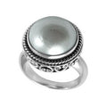 Wholesale sterling silver mother of pearl ring with polished cabochon stone, rope bezel, and Balinese scroll detailing – handcrafted artisan jewelry from Bali.
