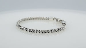 Wholesale sterling silver bracelet featuring a 4MM artisan-woven chain design with polished oxidized details and a decorative lobster lock for secure fastening.