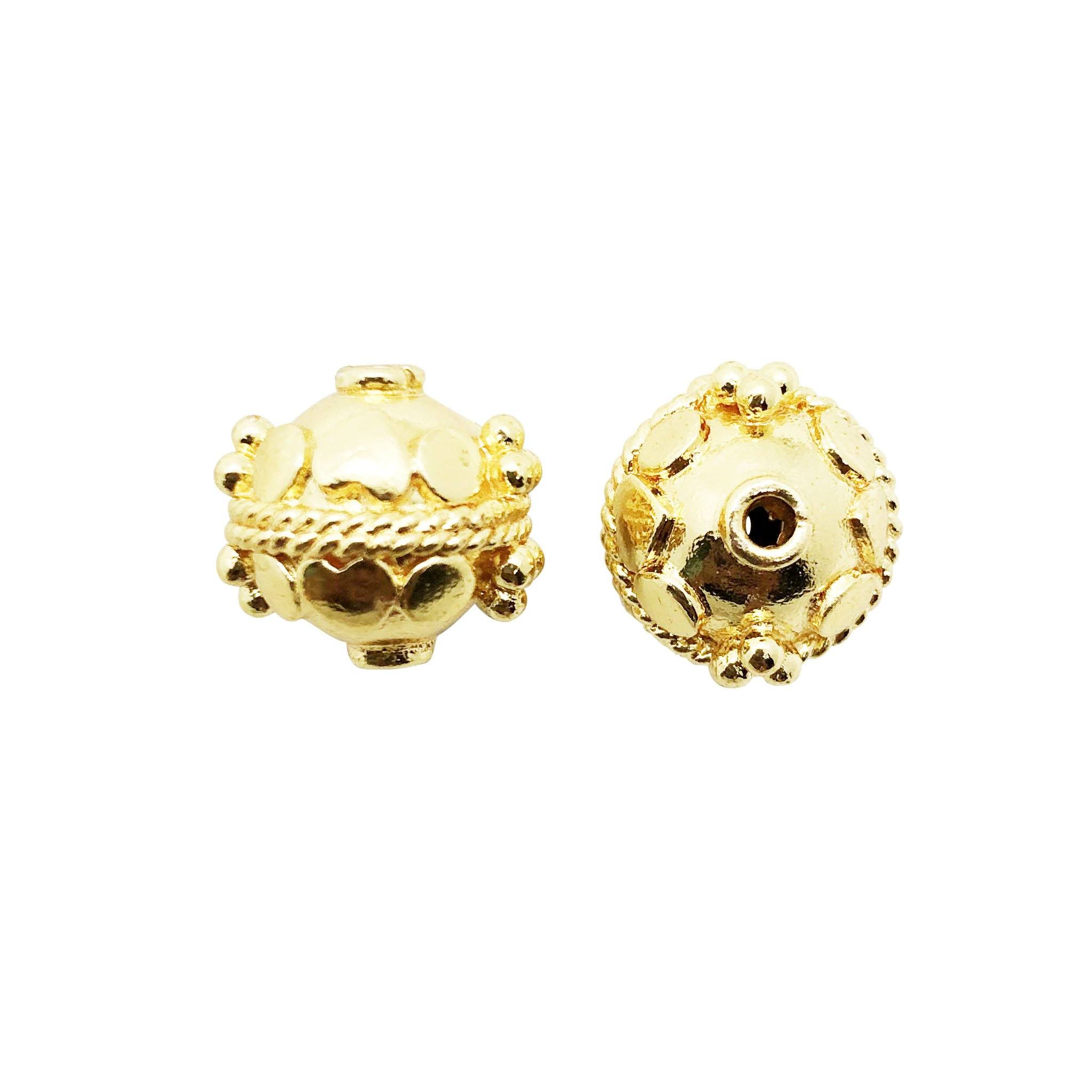 Round dome-shaped bead with 18K gold overlay over copper featuring raised decorative patterns handcrafted in India