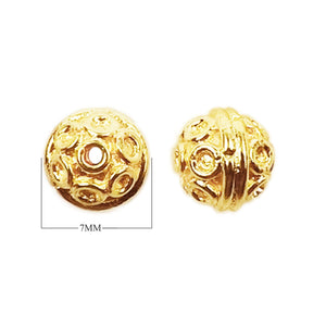 Handcrafted embossed round bead with circular motifs and 18K gold overlay over copper, made in India for wholesale jewelry production.