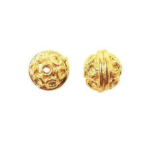 Handcrafted embossed round bead with circular motifs and 18K gold overlay over copper, made in India for wholesale jewelry production.