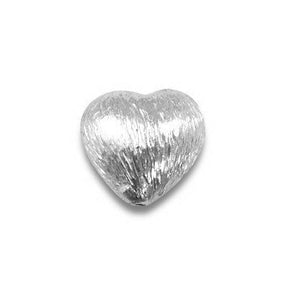 Handcrafted silver heart textured bead with silver overlay over copper, made in India for wholesale jewelry making.