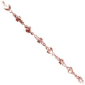 Rose gold overlay over copper heart and cross link chain with polished finish and decorative motifs displayed for wholesale jewelry manufacturing use